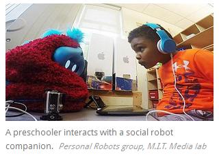 A preschooler interacts with a social robot companion.