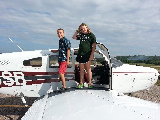 Mimi Hosmer and Mitch Townsend deplane following their chance to fly an aircraft as part of the 2014 ACE Academy Flight Orientation Program.